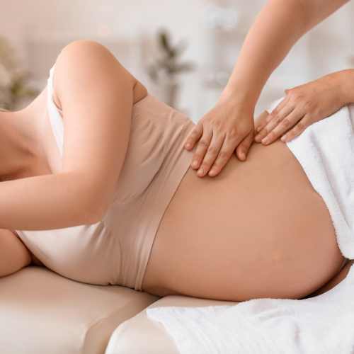 a pregnant woman who has just had reflexology treatment in Cardiff